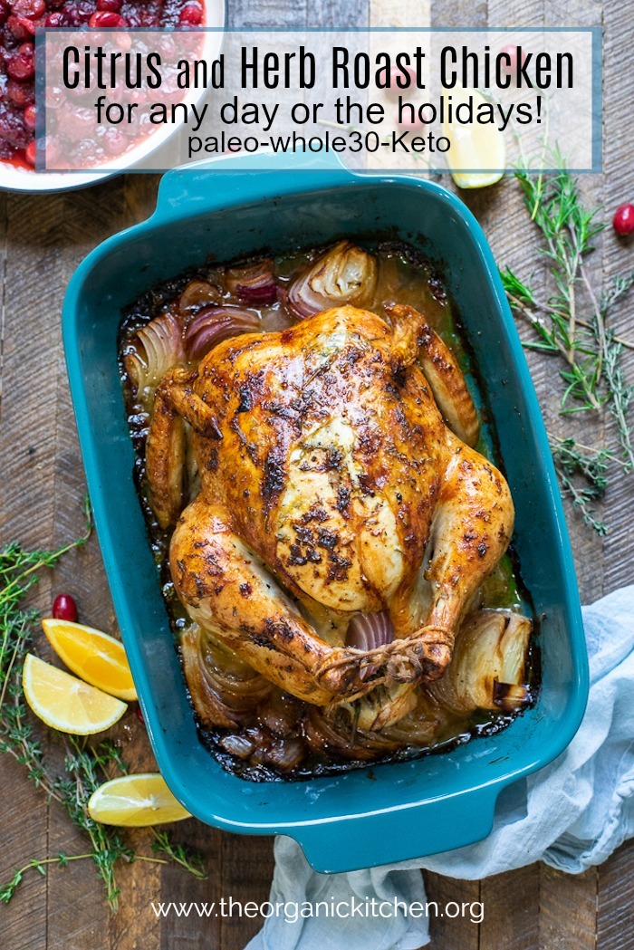 Citrus and Herb Roast Chicken ~ Any Day or Holidays! in a blue dish surrounded by rosemary and cranberries