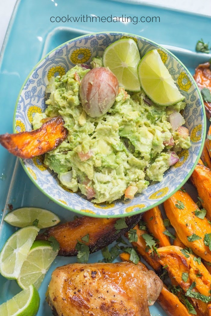 A colocrful bowl of cuacamole with lime wedges as part of 20+ Whole30 Dips, Sauces and Salad Dressings!