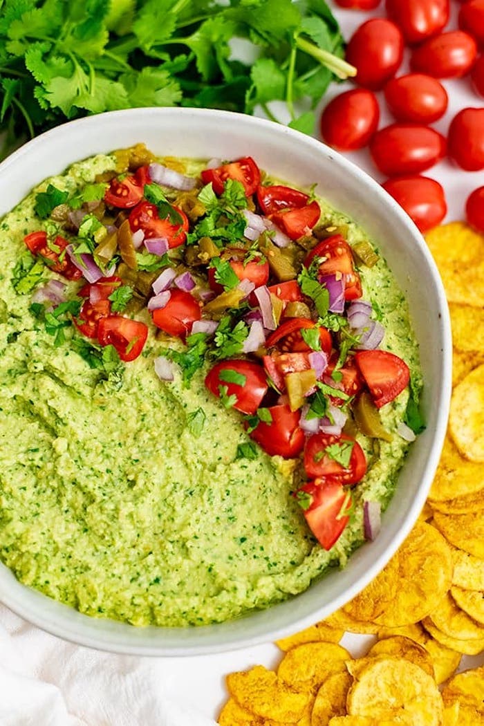 A bowl full of green hummus and salsa as part of 20+ Whole30 Dips, Sauces and Salad Dressings! 