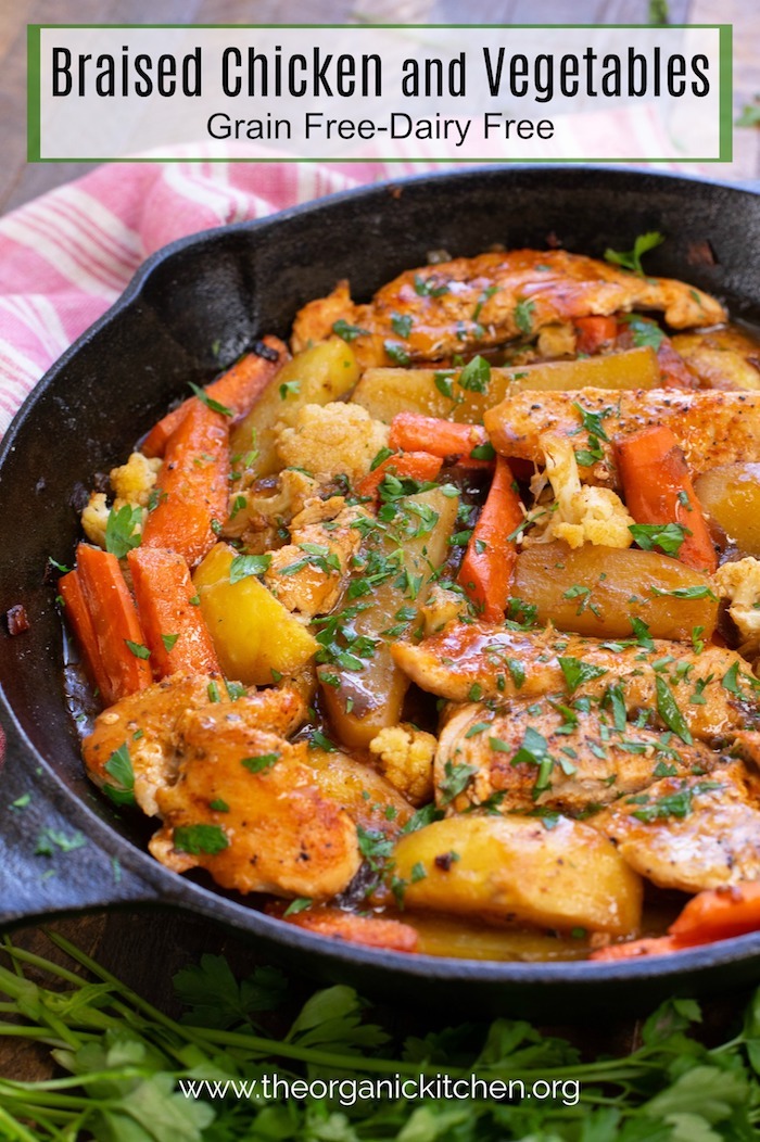 A black cast iron skillet filled with One Pan Braised Chicken and Vegetables