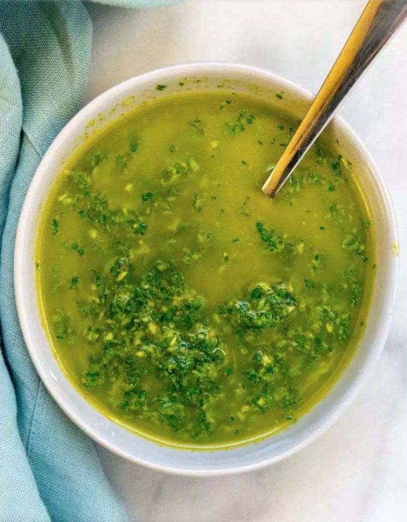 A green sauce  in white bowl on white table as part of 20+ Whole30 Dips, Sauces and Salad Dressings!