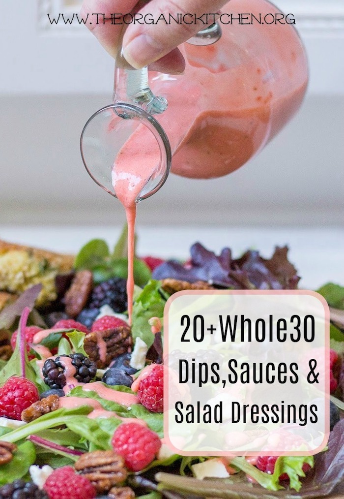 A woman pouring strawberry salad dressing on a salad as part of 20+ Whole30 Dips, Sauces and Salad Dressings! 