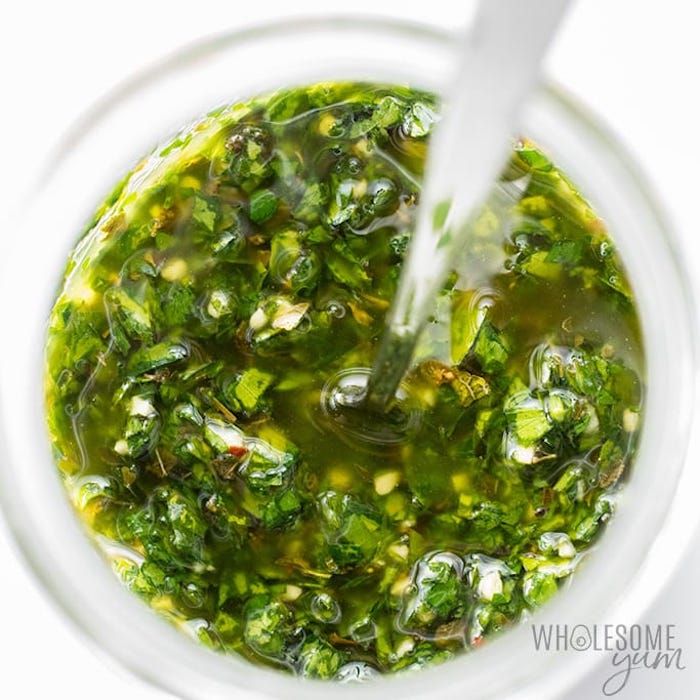 A close up of chimichurri  sauce in a bowl as part of 20+ Whole30 Dips, Sauces and Salad Dressings!