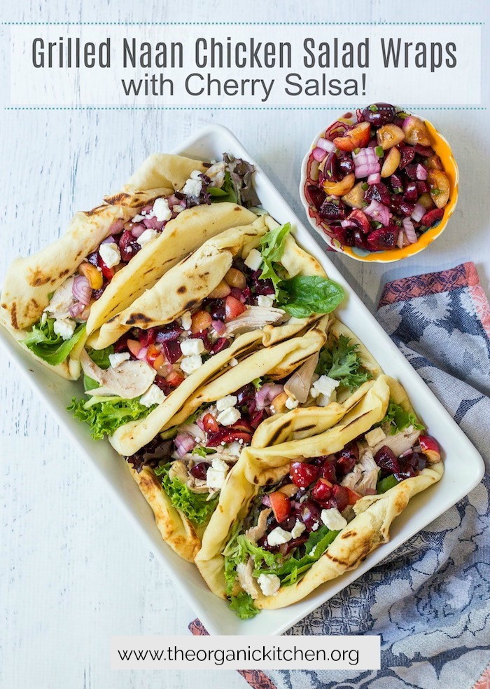 Grilled Naan Chicken Salad Wraps with Cherry Salsa in a white baking dish with a small bowl of cherry salsa