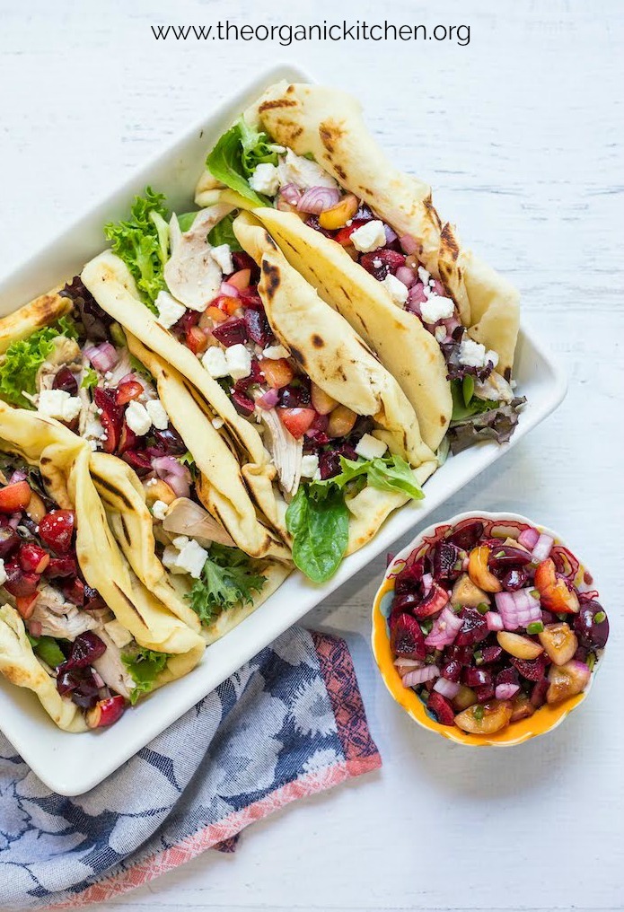 Grilled Naan Chicken Salad Wraps with Cherry Salsa on white surface