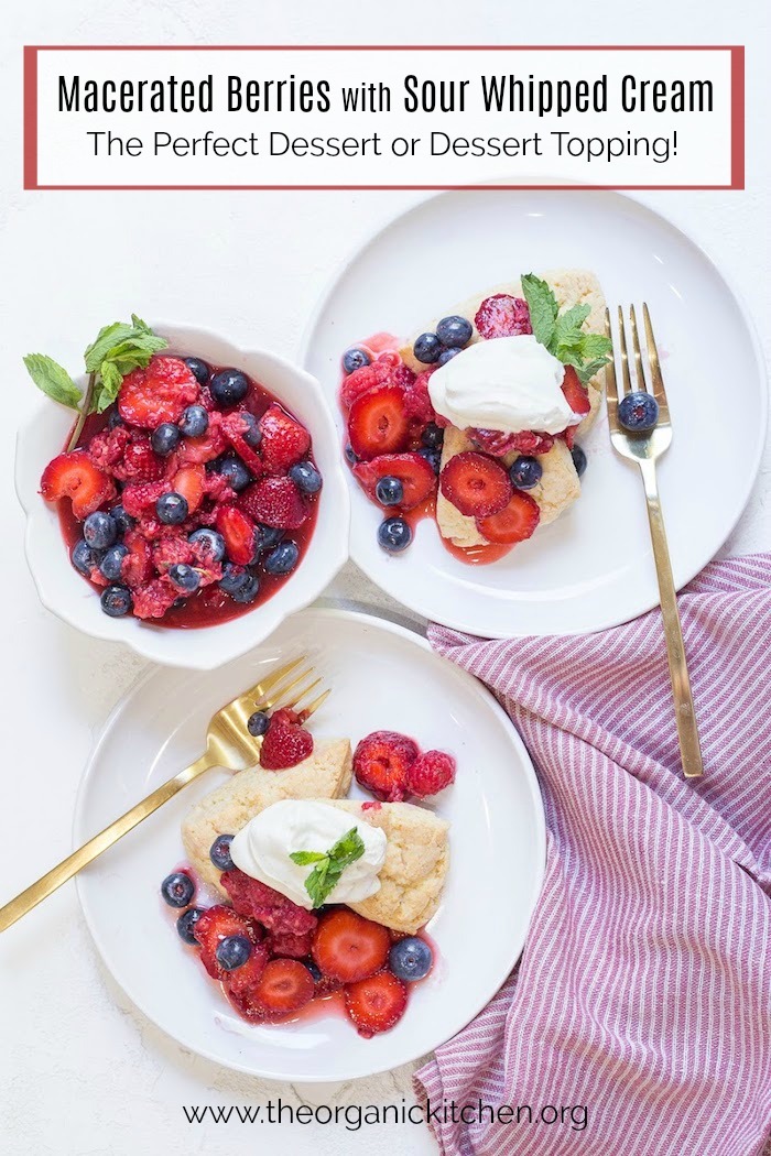 Two white plates with Macerated Berries and Sour Whipped Cream set on a white table
