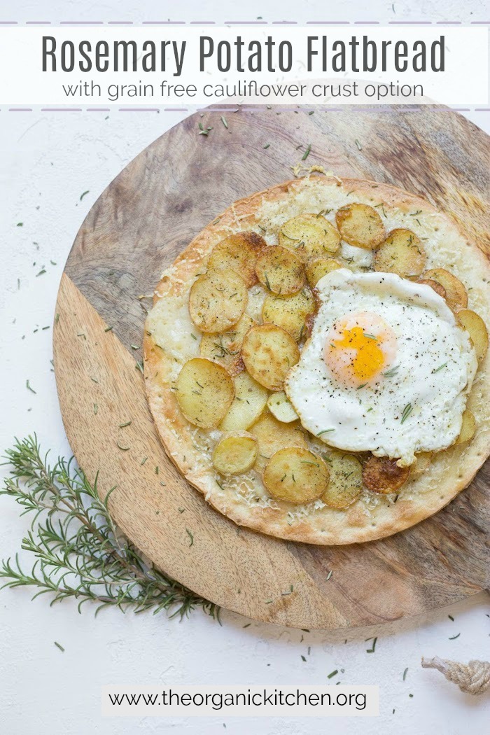 Rosemary Potato Flatbread with Cauliflower Crust Option topped with a fried egg on a wooden board