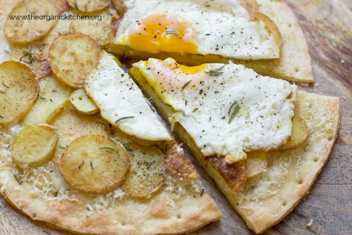 A Rosemary Potato Flatbread with Cauliflower Crust Option with a fried egg with runny yolk