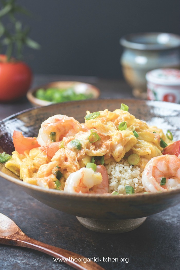 Silky Egg Stir Fry with Jumbo Shrimp in a gray bowl with a wooden spoon in the foreground