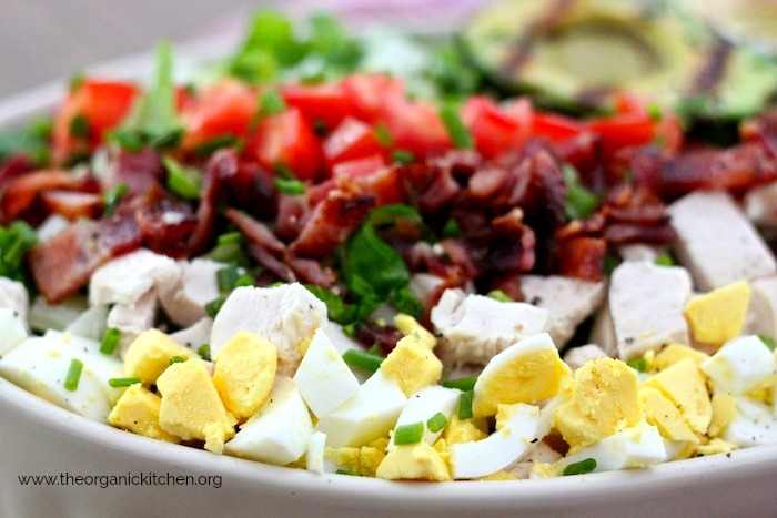 A close up photo of Grilled Avocado Cobb Salad (Keto-Paleo-Whole30) in white dish