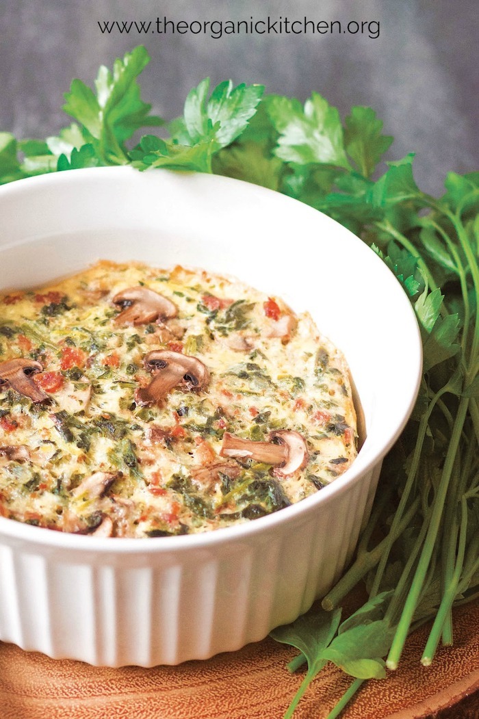 Instant Pot Crustless Veggie and Bacon Quiche in white baking dish garnished with greens