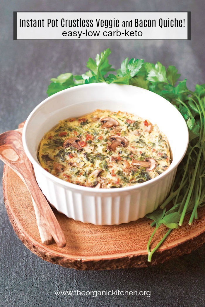 Instant Pot Crustless Veggie and Bacon Quiche in round baking dish on wooden board surrounded by greens and wooden spoons