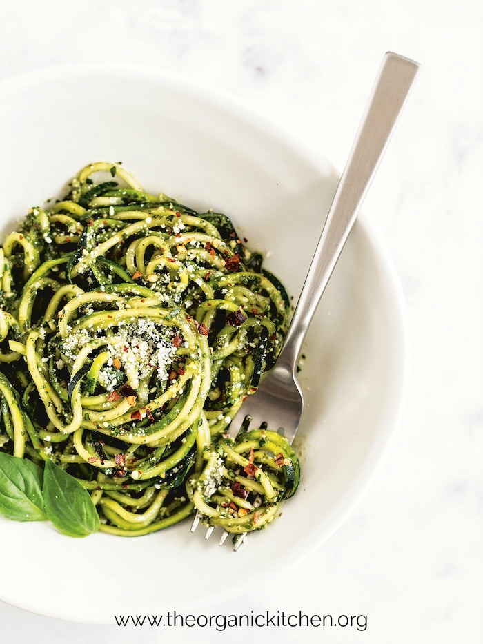 Almond Pesto Zucchini Noodles with silver fork in white bowl