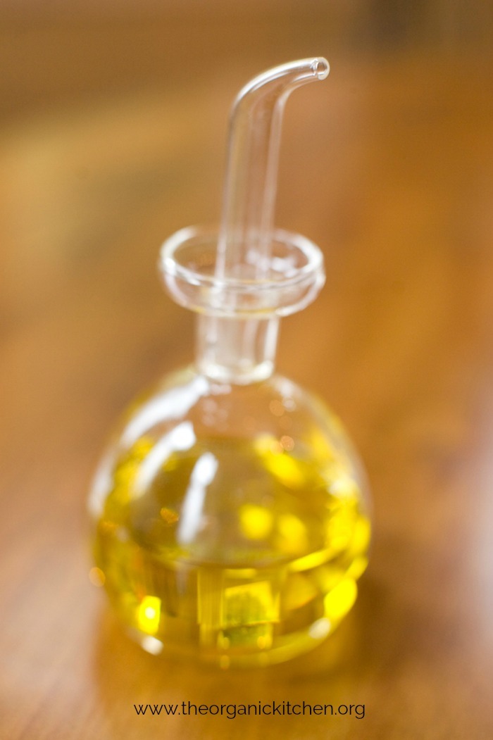 A clear bottle of golden salad dressing for Roasted Carrot and Brown Rice Salad