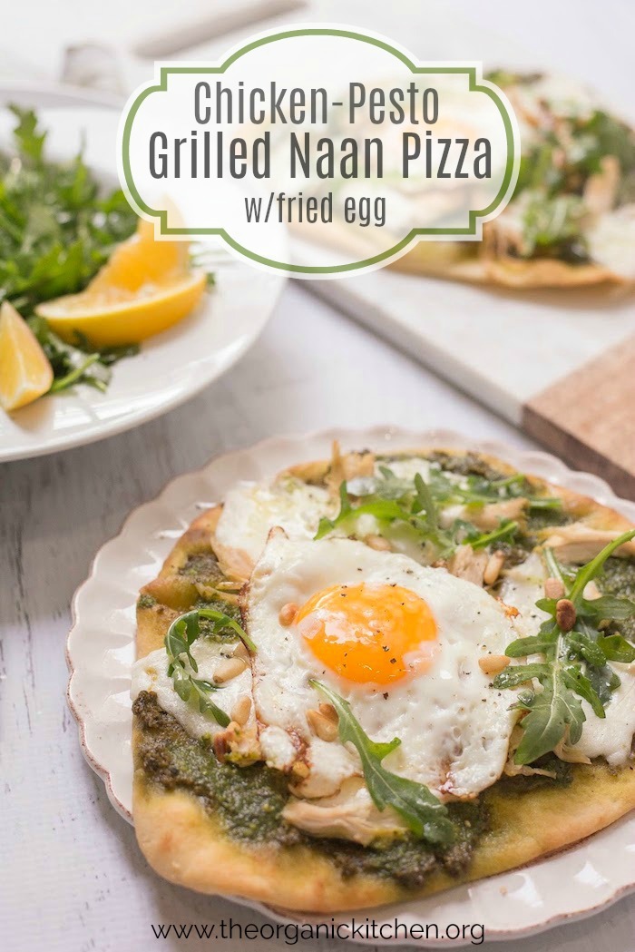 Chicken Pesto Burrata Naan Pizza with Fried Egg garnished with arugula on white plate