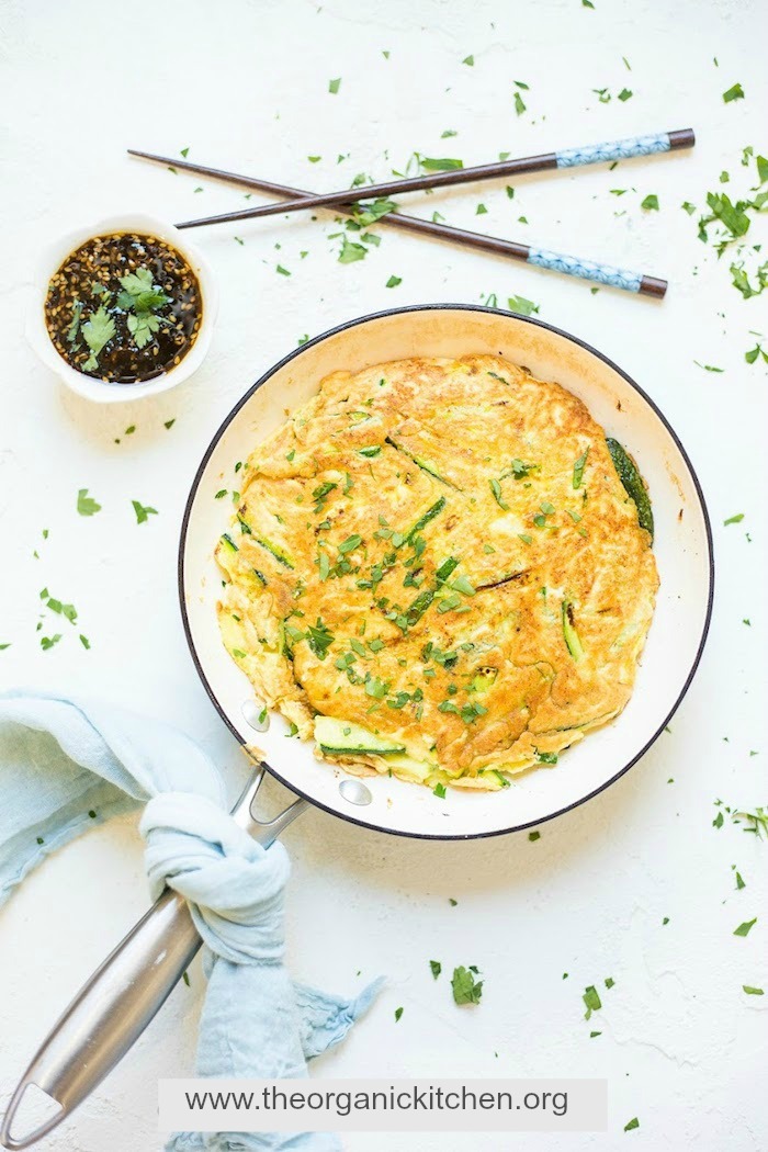 A white pan with Korean Breakfast Pancake, dipping sauce and chop sticks, one of 12 Healthy, Delicious (Whole 30) Breakfast Recipes!