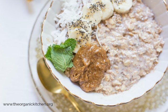 A bowl Maple, Almond Butter and Banana Overnight Oats with sliced bananas, almond butter and chia seeds