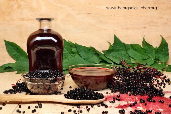 Elderberry Syrup with Low Carb Option in glass jar surrounded by elderberries