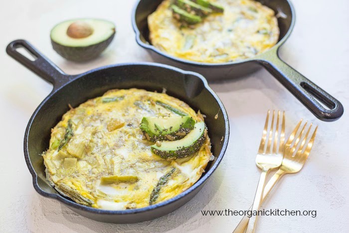 Sliced avocados on frittatas in black cast iron pans