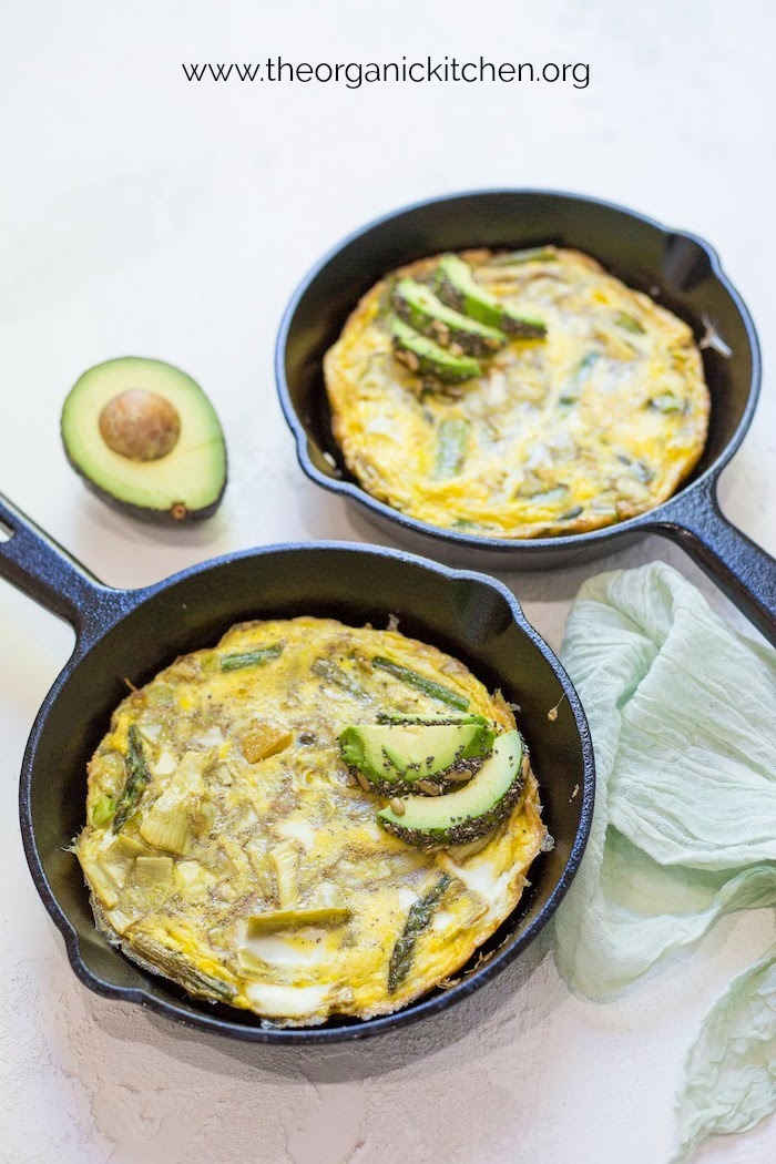 Two pans of Spring Frittata with Seeded Avocado with green cloth