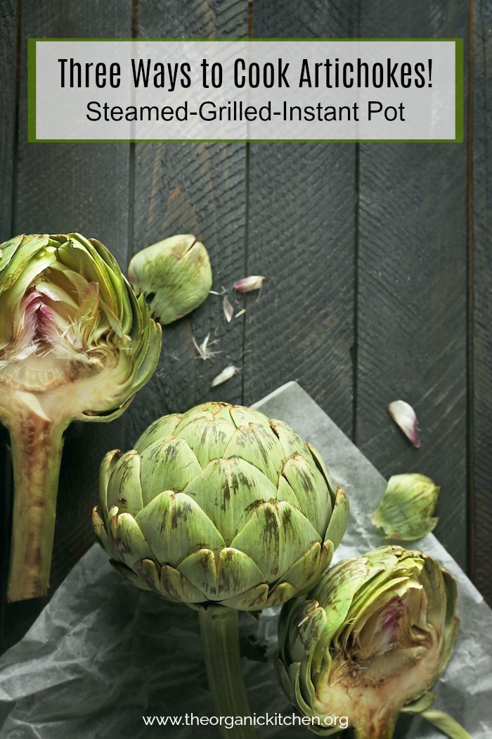 Artichokes on a gray wood surface