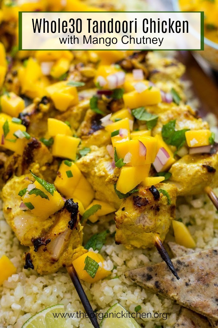 A close up of Whole30 Tandoori Chicken with mango chutney on a bed of cauliflower rice