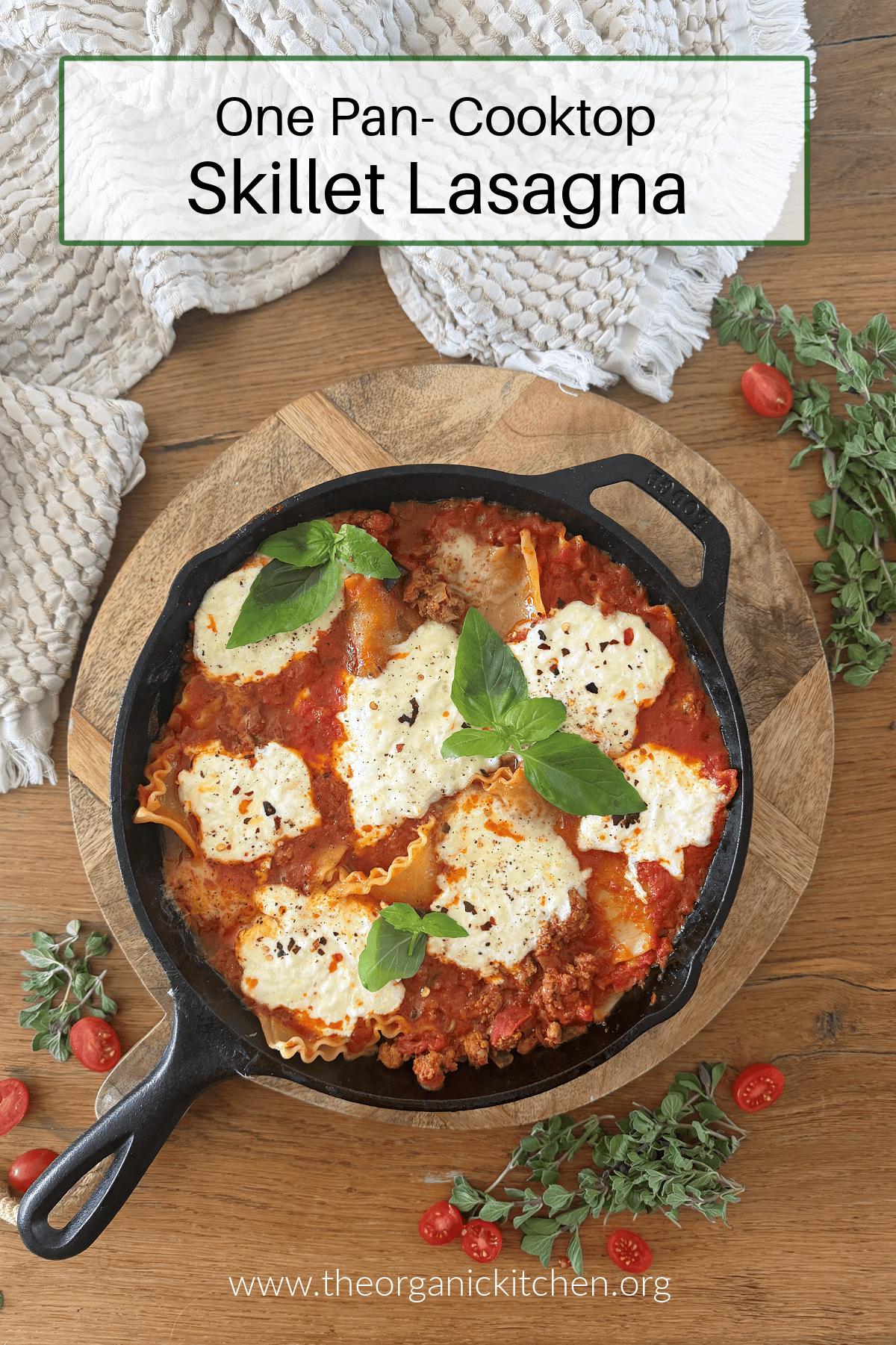 Stove Top Skillet Lasagna in black cast iron pan, garnished with basil on wood cutting board