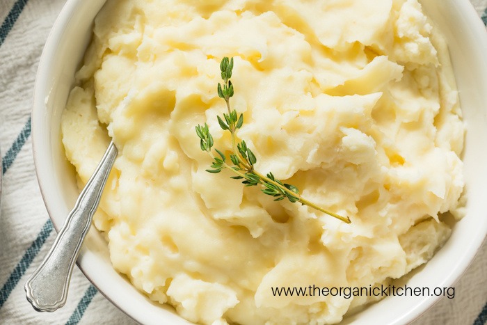 Homemade Thanksgiving Mashed Potatoes with Thyme, Salt and Pepper in white bowl