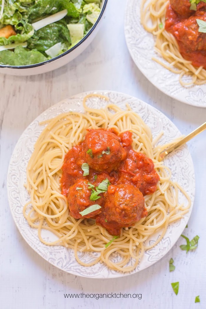 Spaghetti with Homemade Meatballs on white plate with gold fork