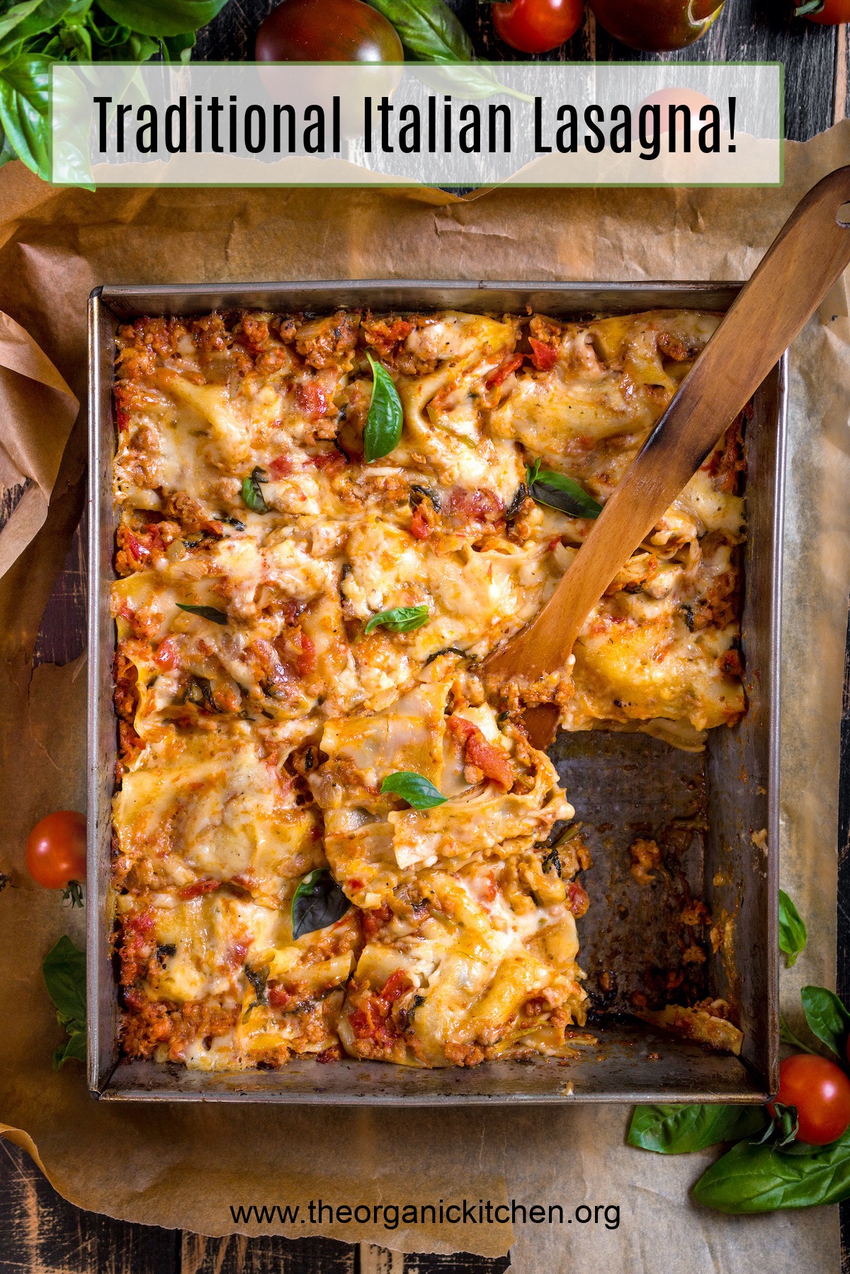 Traditional Italian Lasagna topped with basil leaves served on a rustic dark wooden table