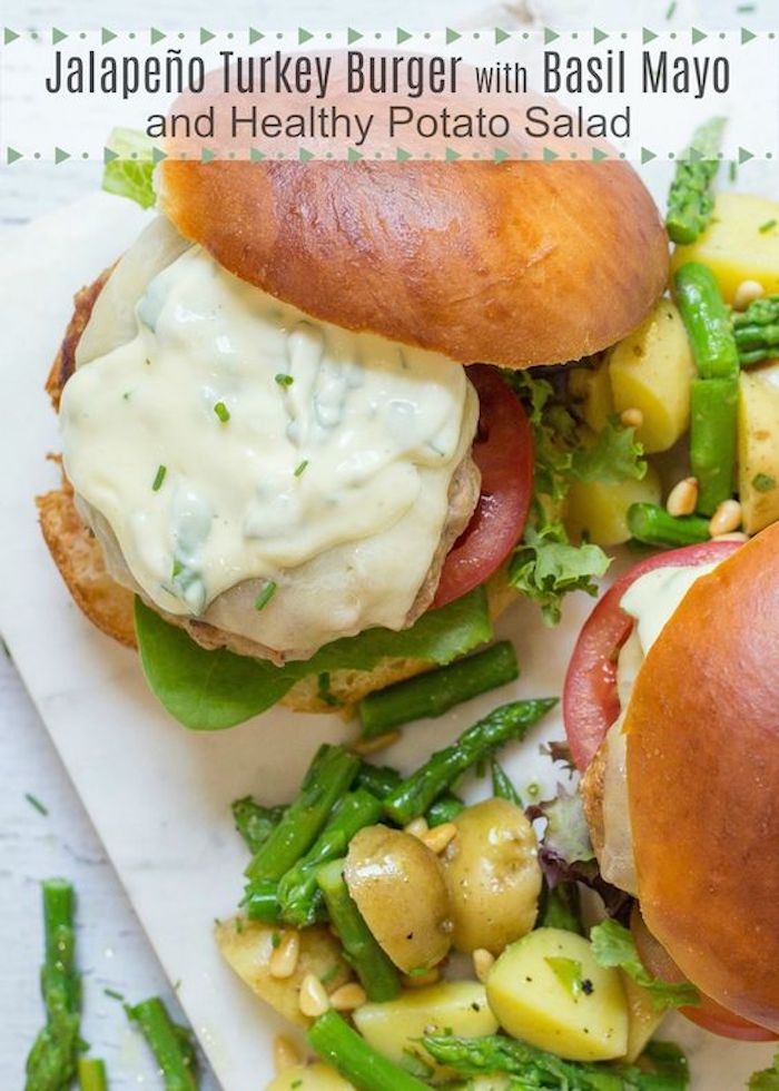 Jalapeño Turkey Burgers with Basil Mayo surround by potato salad on white platter