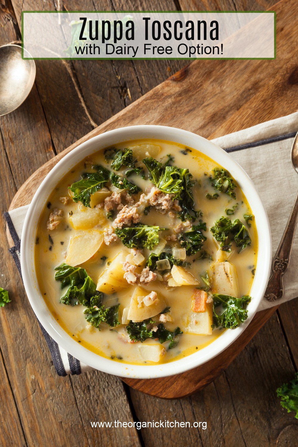 A white bowl on a wood table filled with Zuppa Toscana (with Dairy free option)
