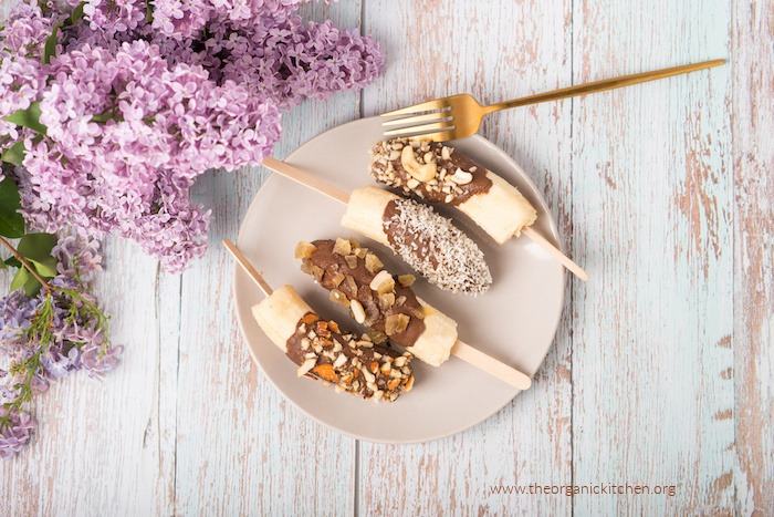 Chocolate frozen bananas on white plate