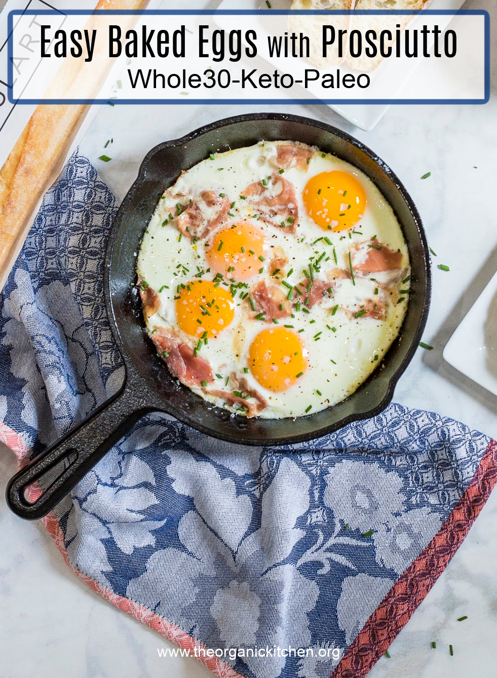 Baked Eggs and Prosciutto in a black cast iron skillet set on a dish towel