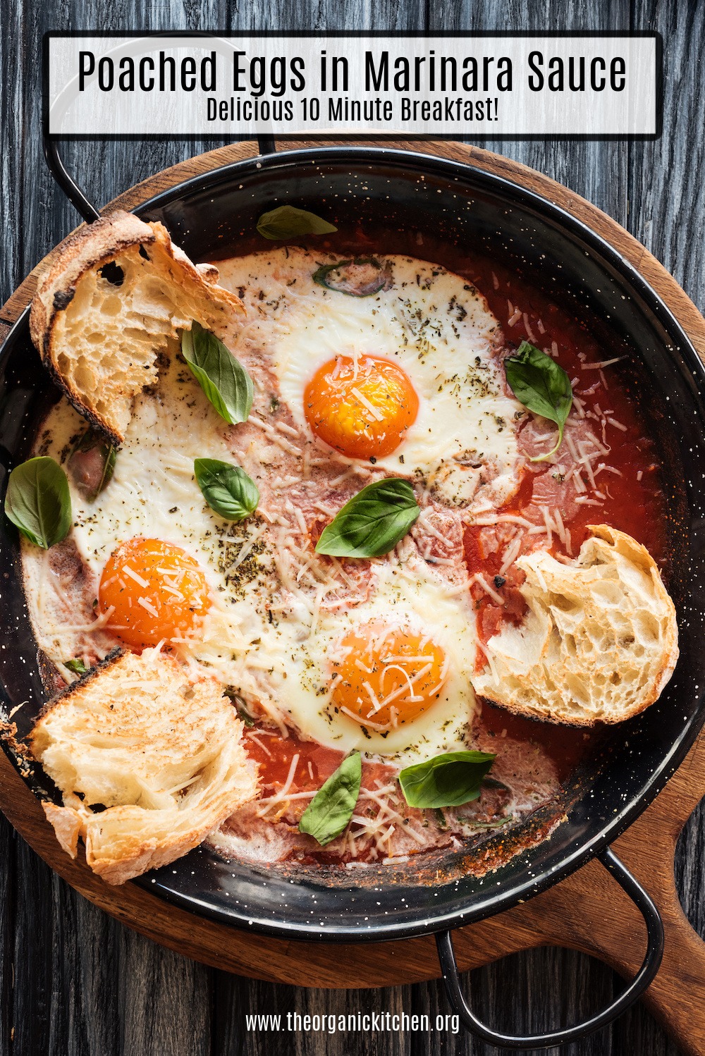 Poached Eggs in Marinara Sauce with toast in a black pan set on a wooden board