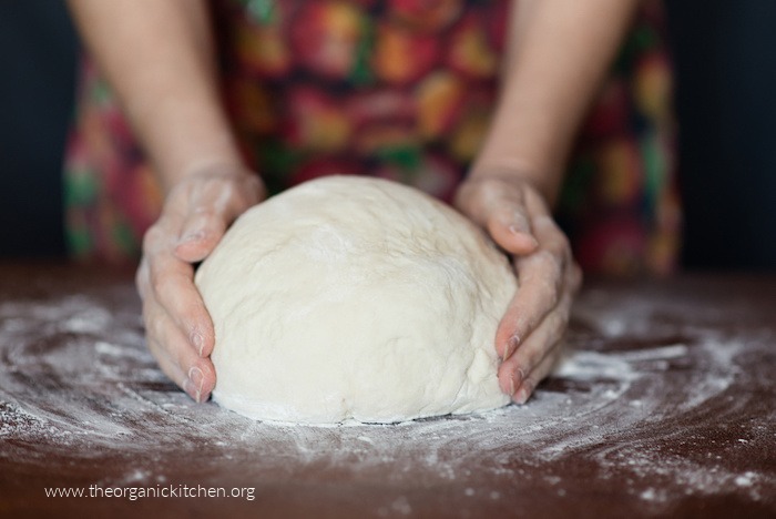 A female forming a loaf of sourdough with her hands