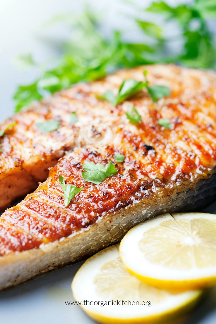 crispy grilled salmon steak with cherry tomatoes and parsley