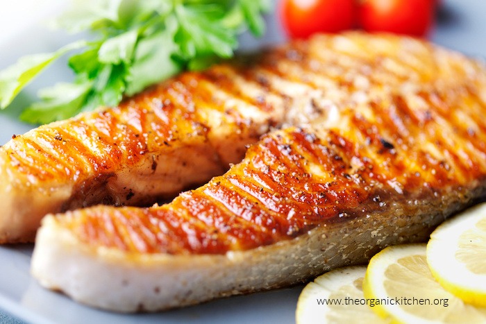 Crispy grilled salmon steak with cherry tomatoes and parsley