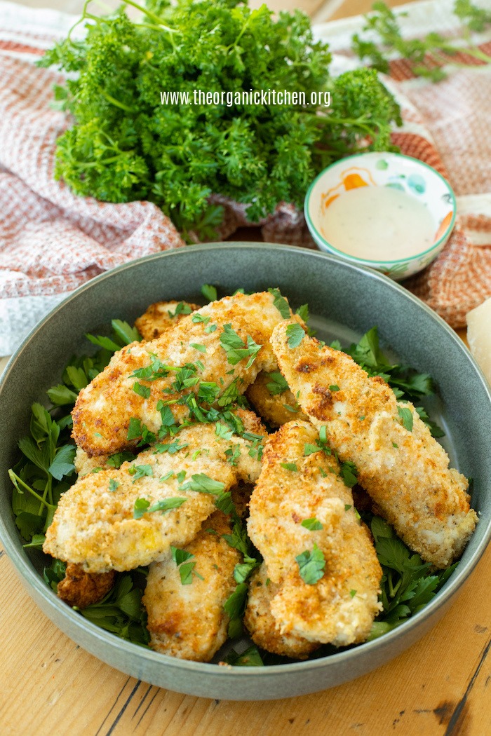 Air Fryer Parmesan Chicken Tenders in a grey bowl with ranch dip and parsley in background