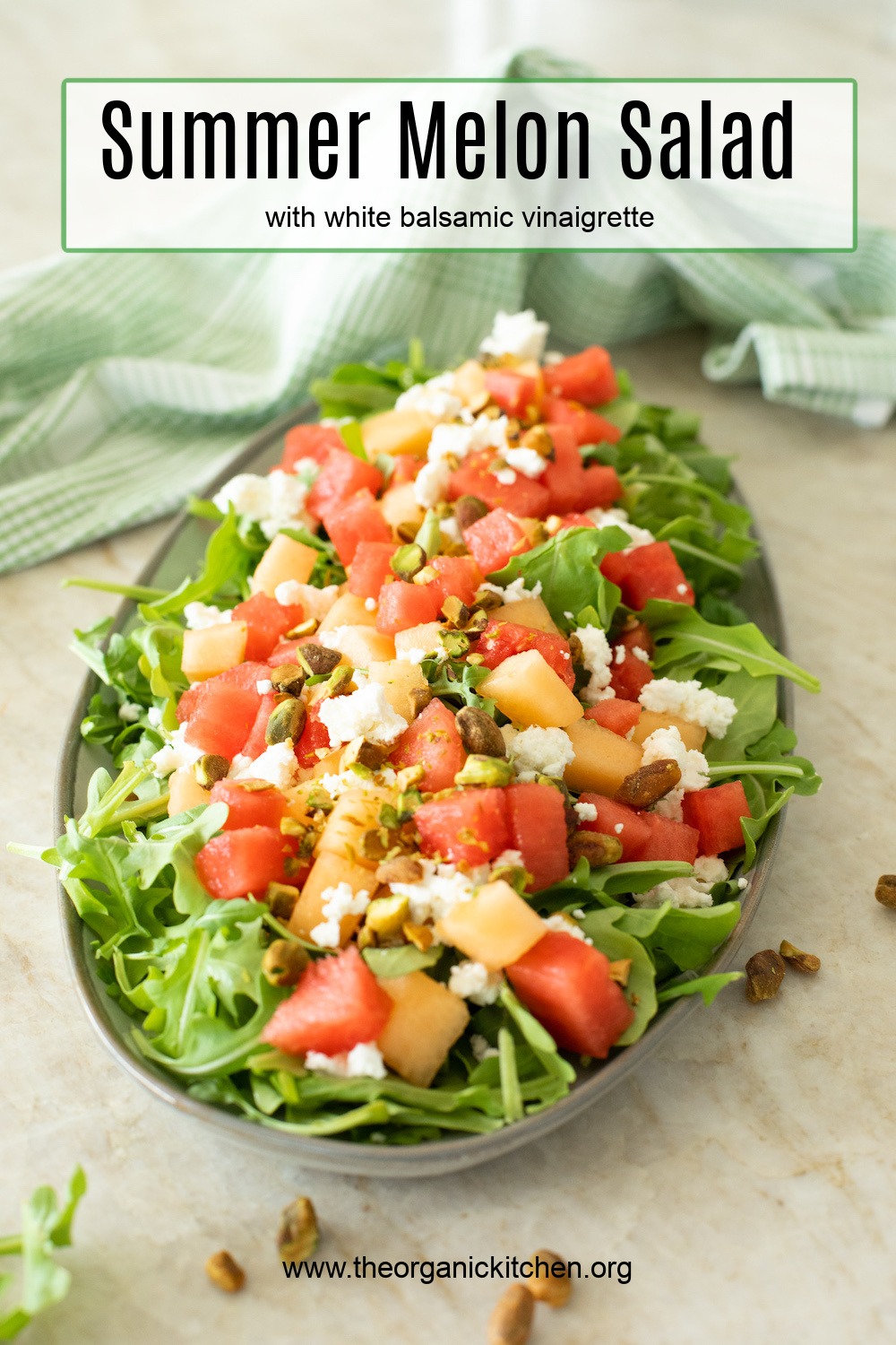 Summer Melon Salad on gray platter with green and white dish towel in background