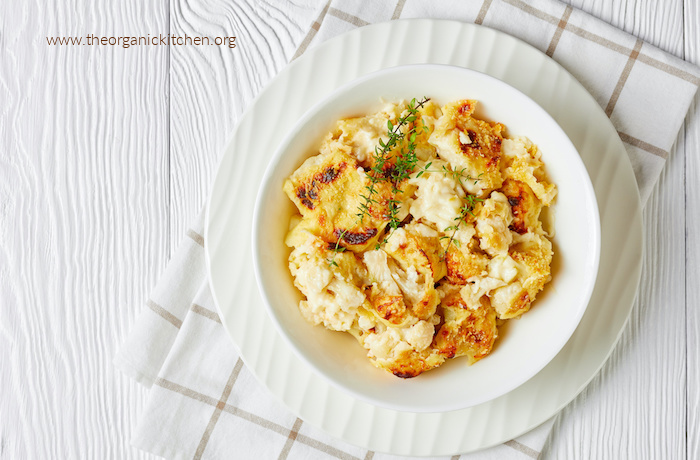 Cauliflower "Mac" and Cheese in white bowl on dish cloth