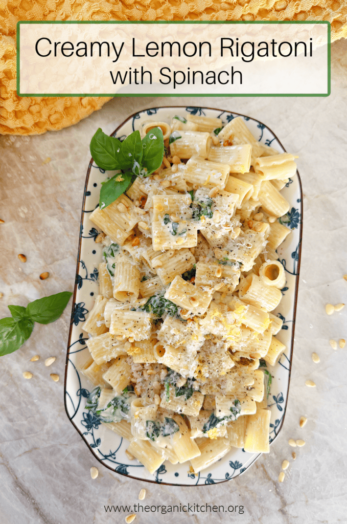 Creamy Lemon Rigatoni on blue and white dish with yellow dish towel in the background