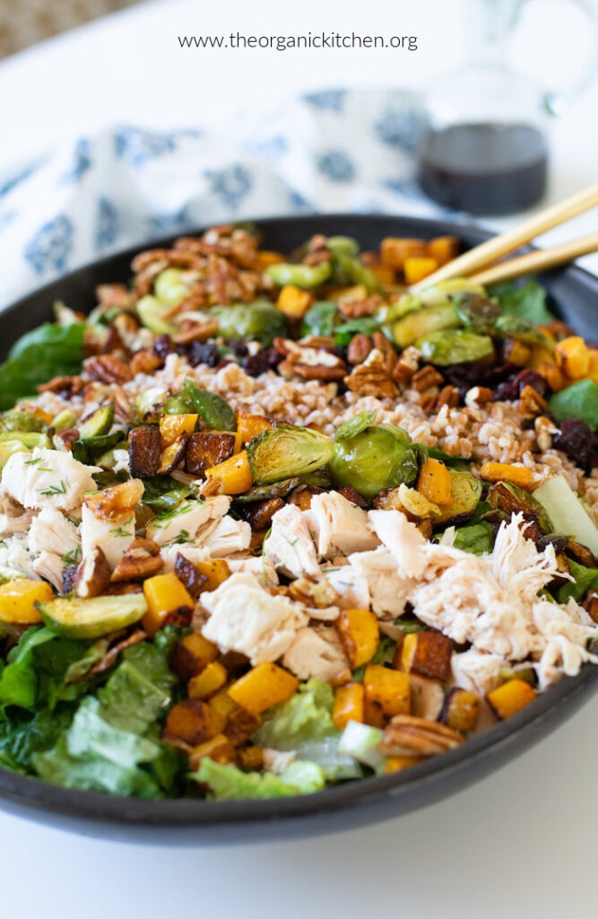 Chicken, Farro, and Roasted Butetrnut Squash Salad in black bowl on white countertop