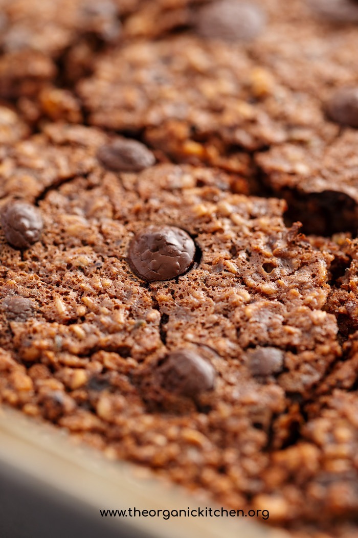 A close up photo of the Vegan Chocolate Almond Butter Oat Bake topped with chocolate chips