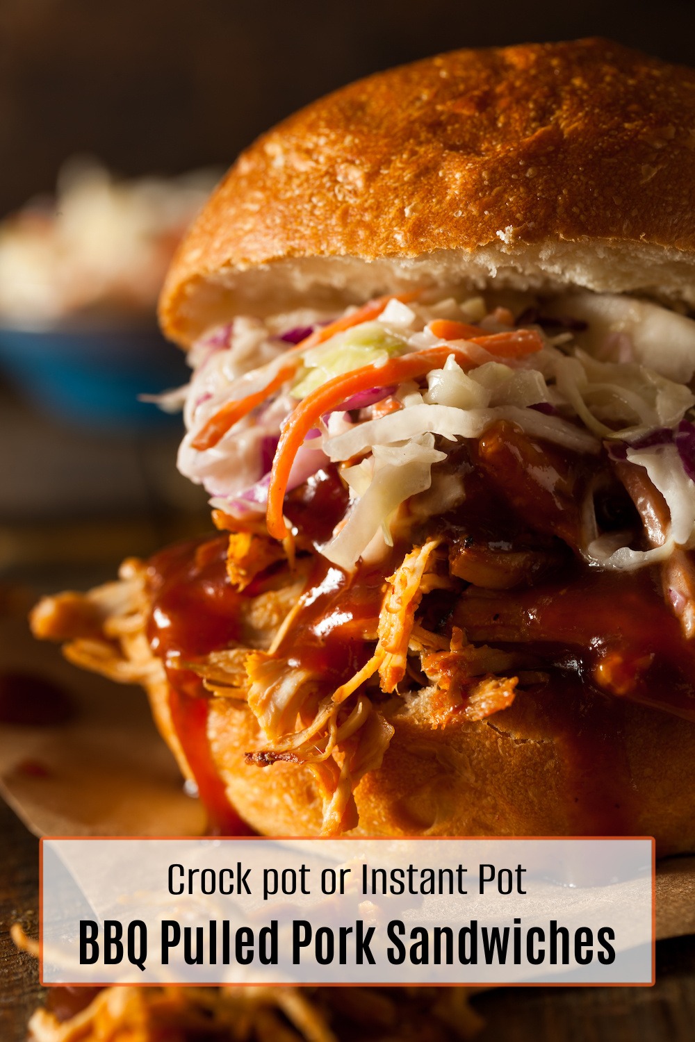 A close up of Crock Pot or Instant Pot BBQ Pulled Pork Sandwiches with coleslaw on wooden board