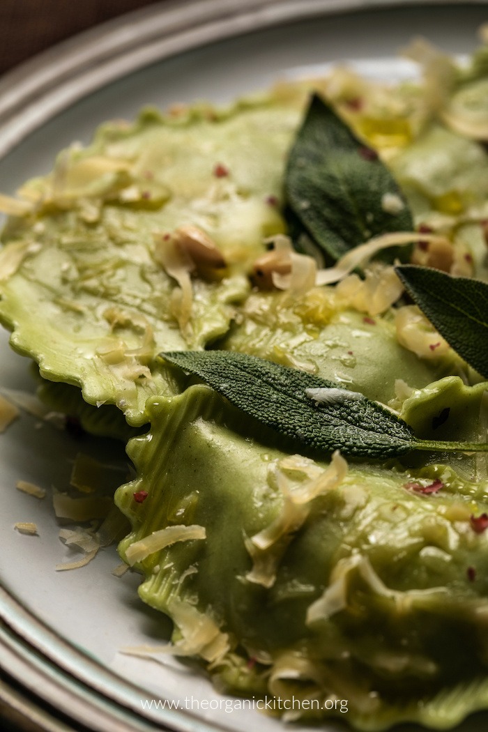 Easy Ravioli with Sage Brown Butter garnished with sage leaves and pine nuts on plate