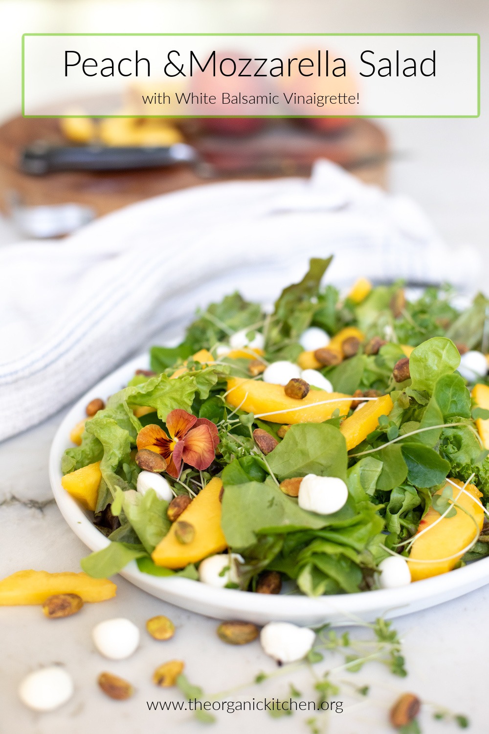 Easy Peach and Mozzarella Salad on white plate with dish towel and cutting board in background