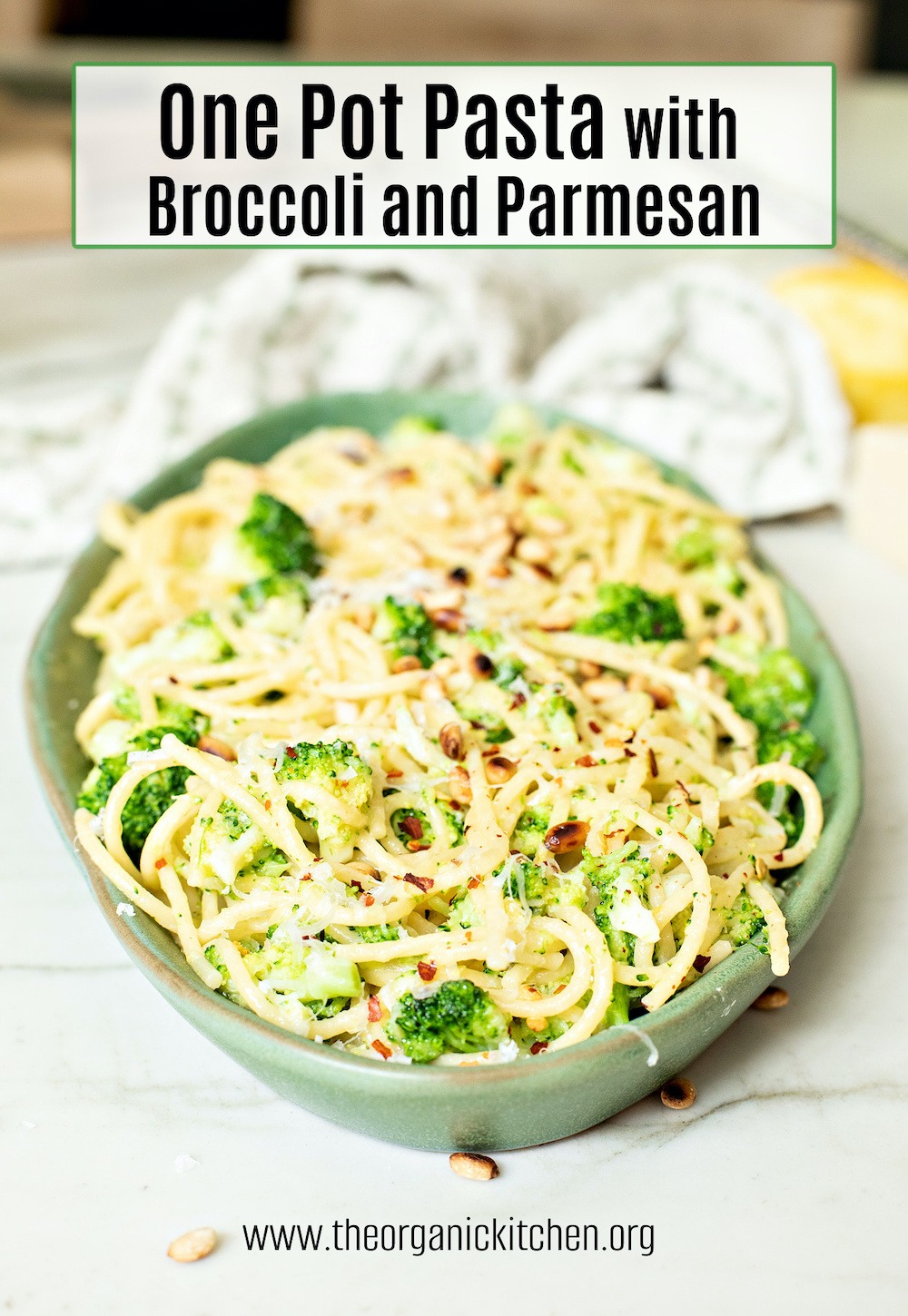 One Pot Pasta with Broccoli and Parmesan on a green plate set on white marble table