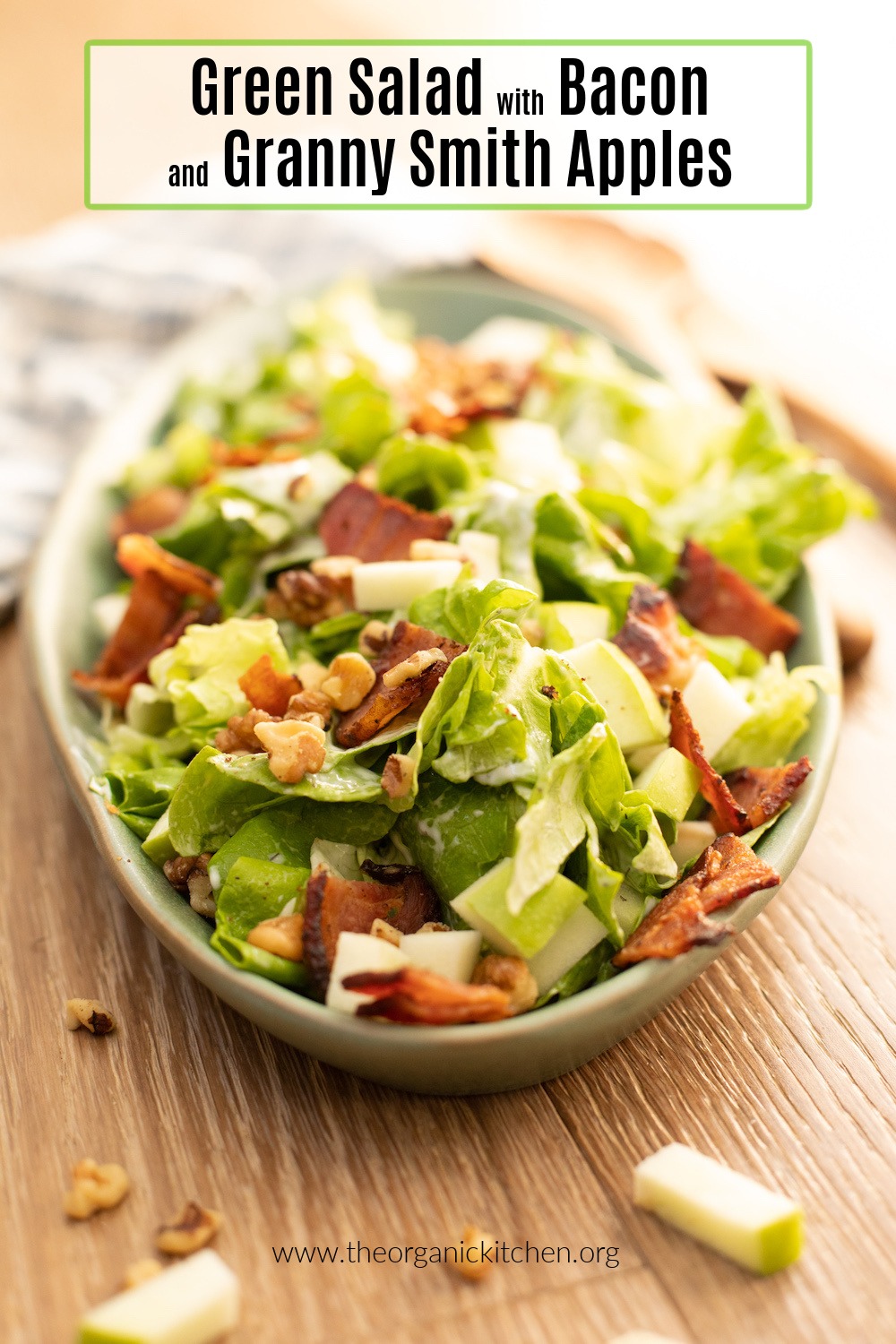 Green Salad with Apples and Bacon (Whole30) on a green platter set on a wood surface