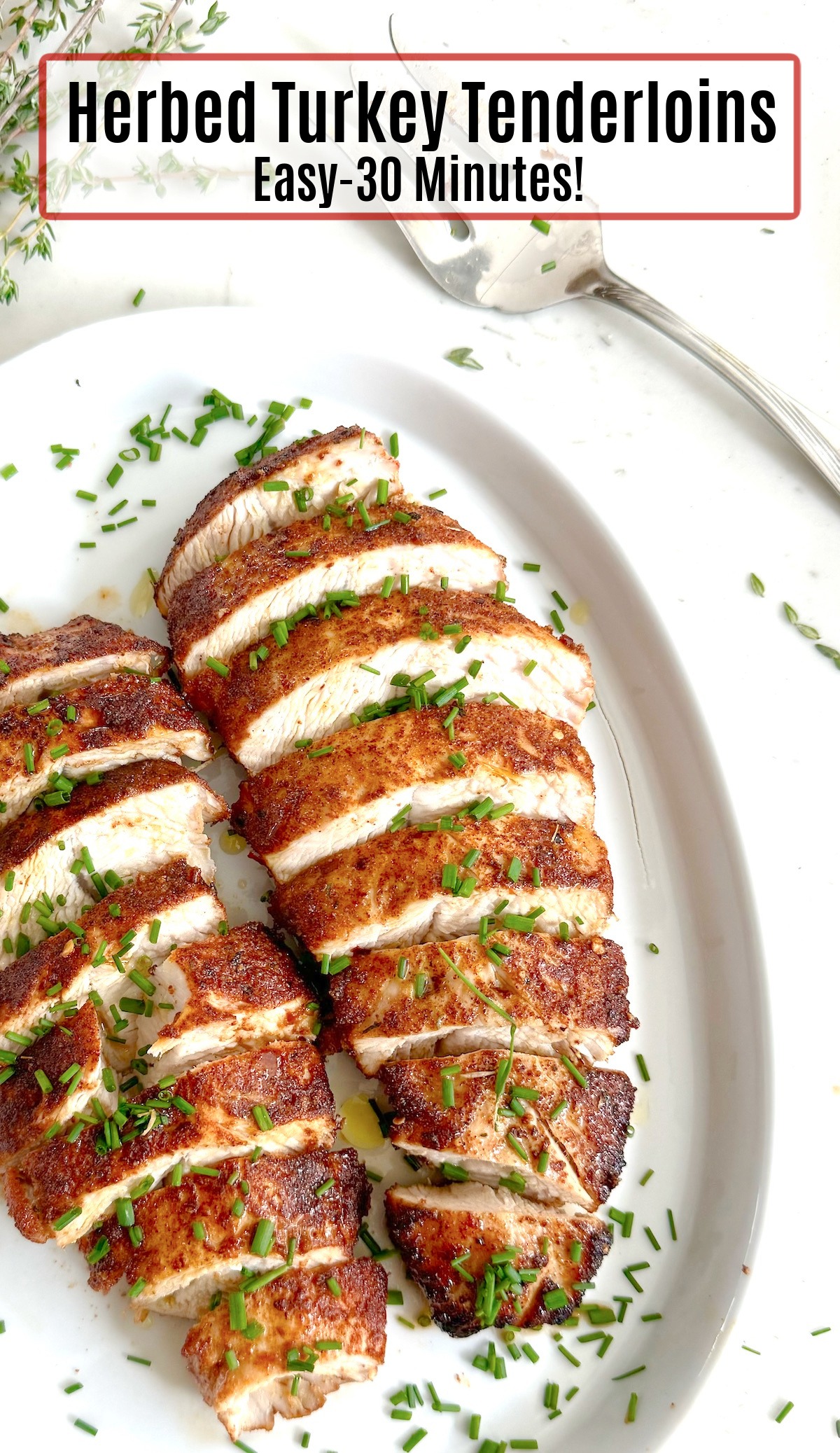 Two Easy Herbed Turkey Tenderloins garnished with chives on a white plate